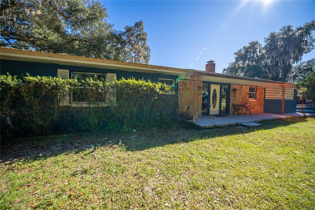 1740 Southeast 164th Circle Ocklawaha, FL 32179 - Photo 47 of 48 a view of a house with backyard and sitting area