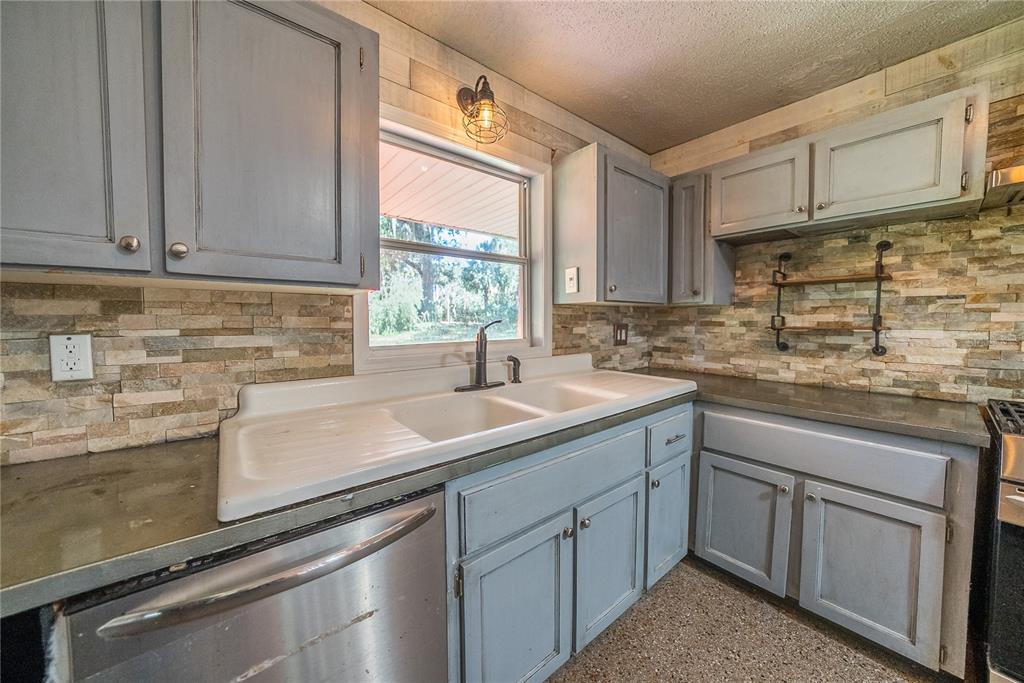 1740 Southeast 164th Circle Ocklawaha, FL 32179 - Photo 8 of 48 a kitchen with stainless steel appliances granite countertop a sink stove and cabinets