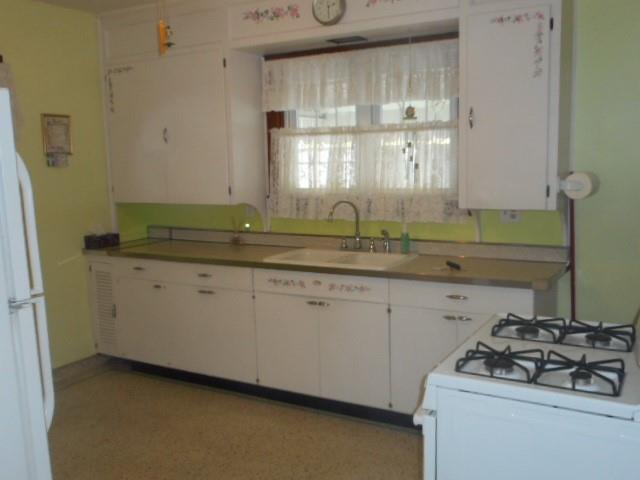 504 1st Street Charleroi, PA 15022 - Photo 7 of 24 a kitchen with a sink stove and cabinets