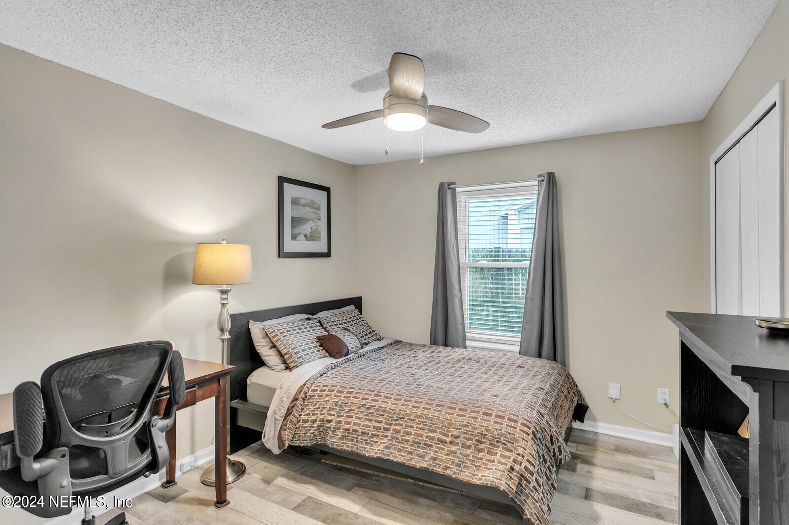 2476 Spring Vale Road Jacksonville, FL 32246 - Photo 13 of 16 a bedroom with a bed and window