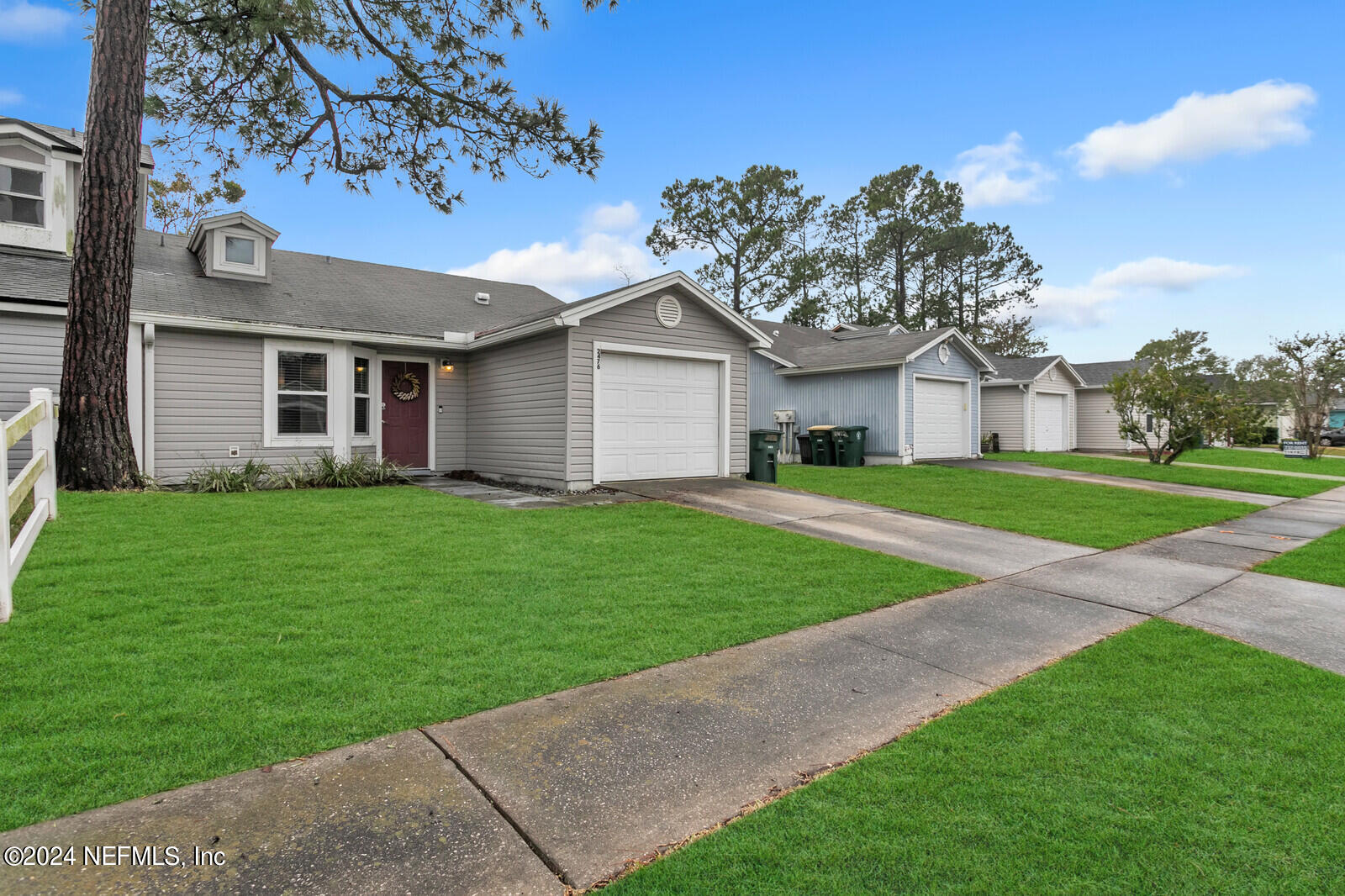 2476 Spring Vale Road Jacksonville, FL 32246 - Photo 14 of 16 a front view of a house with a garden and yard