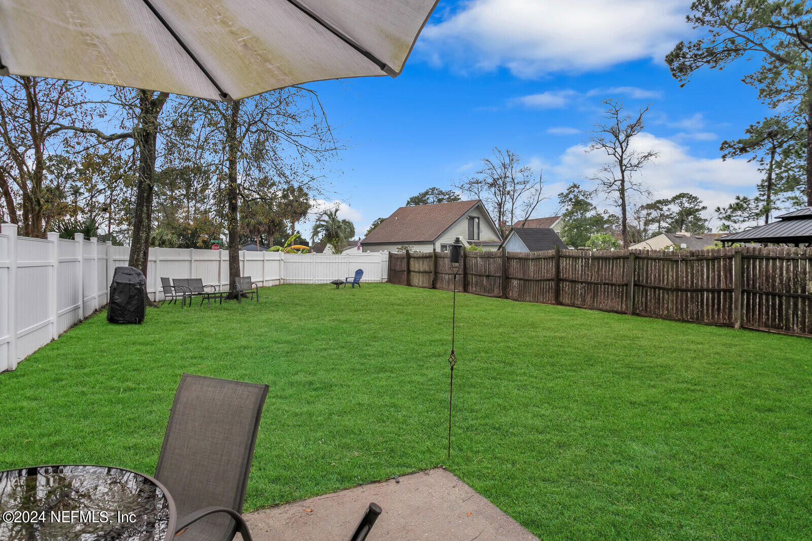 2476 Spring Vale Road Jacksonville, FL 32246 - Photo 15 of 16 a view of a garden with a bench