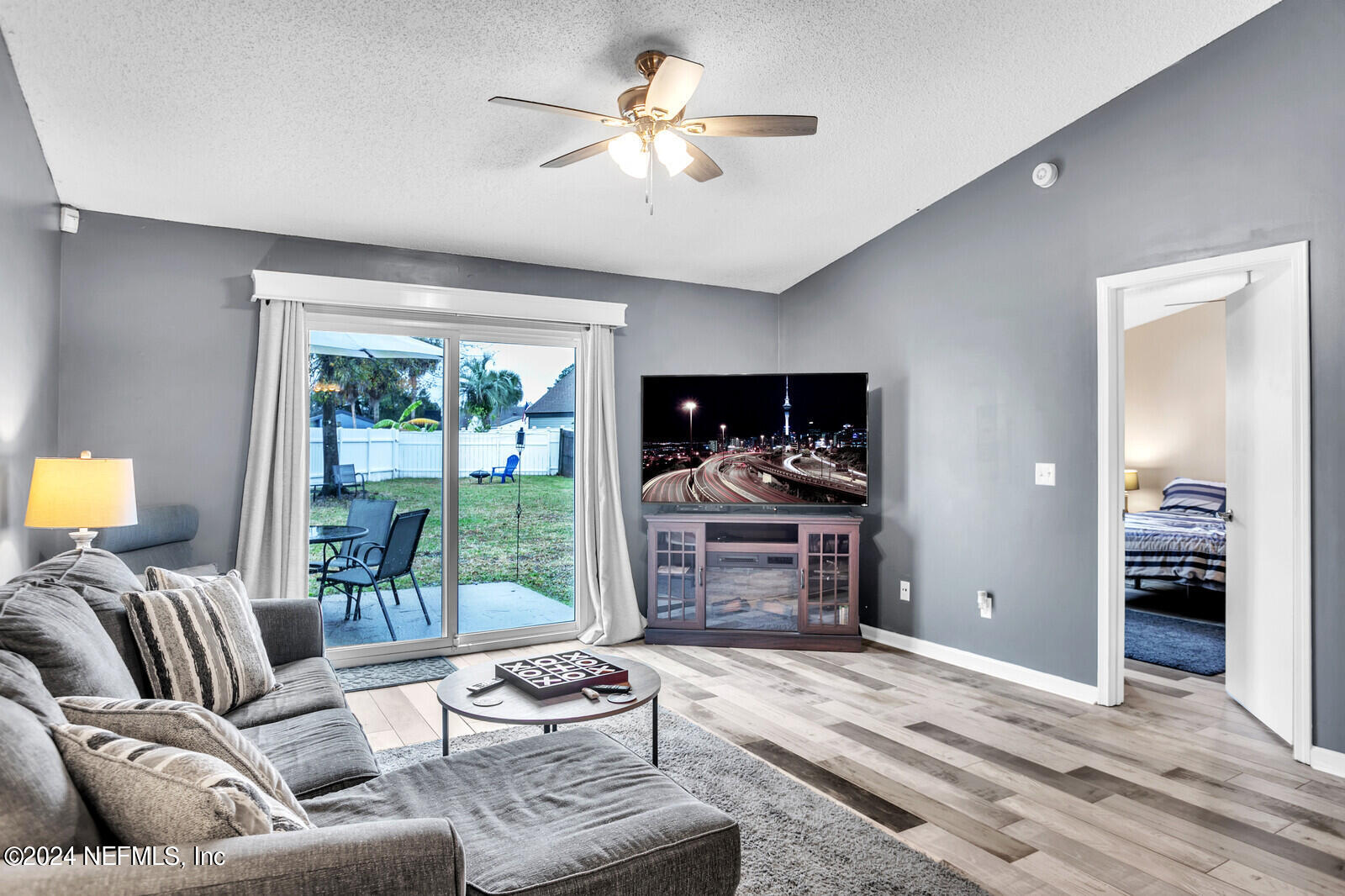 2476 Spring Vale Road Jacksonville, FL 32246 - Photo 5 of 16 a living room with furniture and a floor to ceiling window