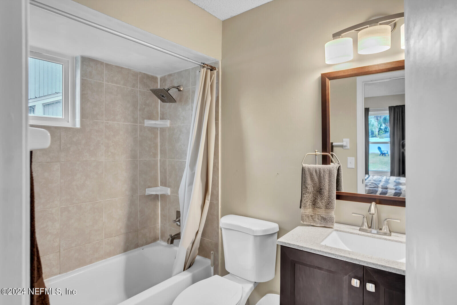 2476 Spring Vale Road Jacksonville, FL 32246 - Photo 6 of 16 a bathroom with a sink toilet and shower