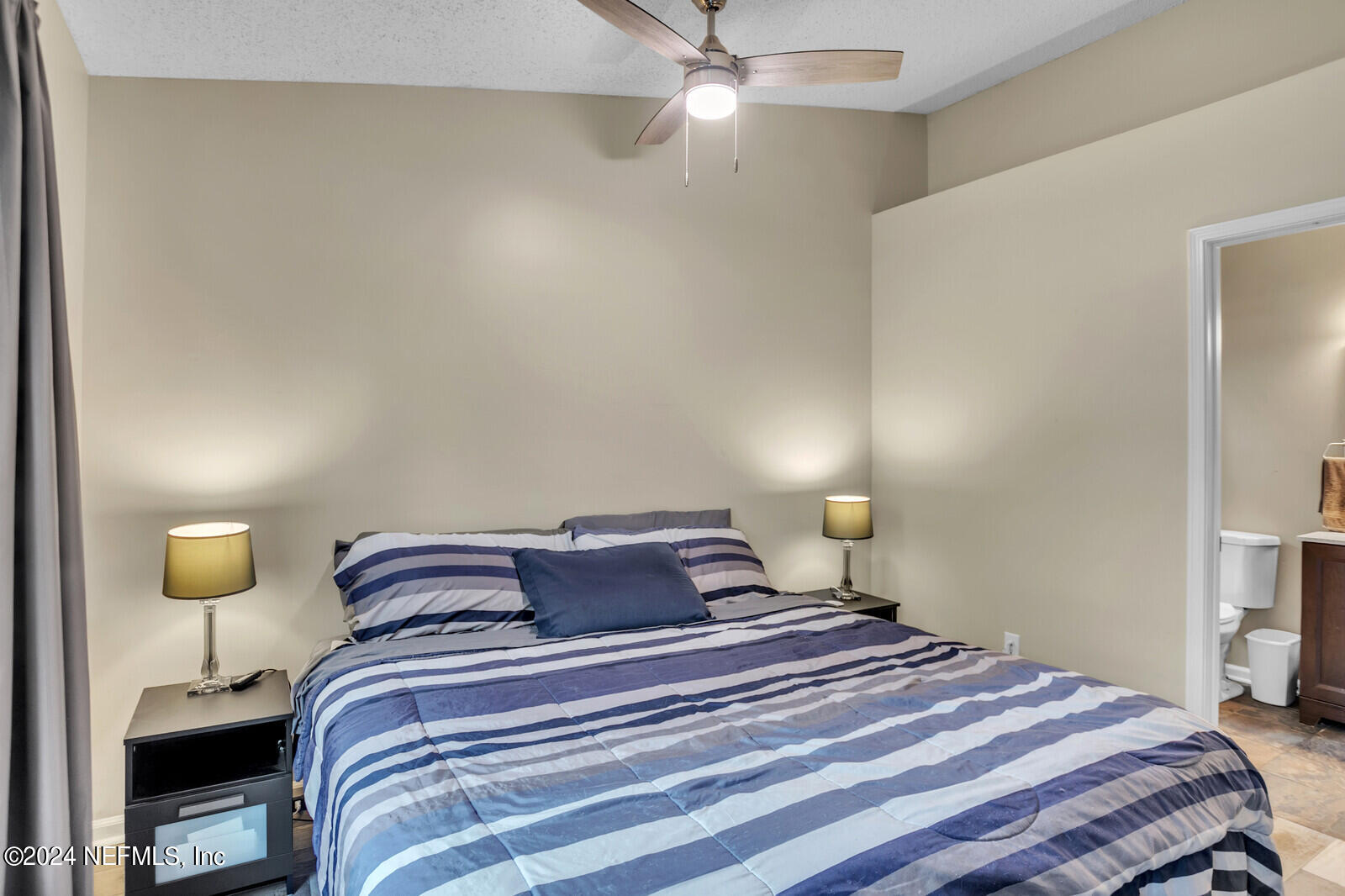 2476 Spring Vale Road Jacksonville, FL 32246 - Photo 7 of 16 a bedroom with a bed and lamps