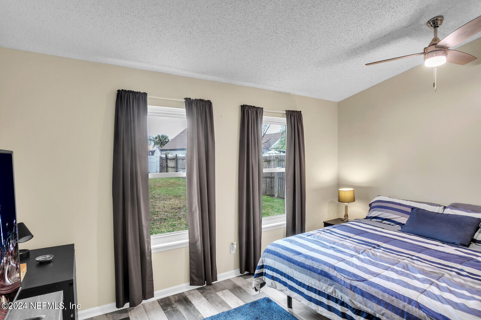 2476 Spring Vale Road Jacksonville, FL 32246 - Photo 8 of 16 a bedroom with a bed and a large window