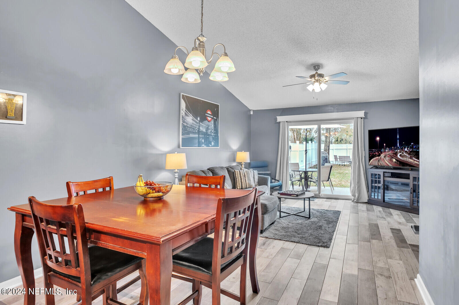 2476 Spring Vale Road Jacksonville, FL 32246 - Photo 10 of 16 a view of a dining room with furniture a chandelier and wooden floor