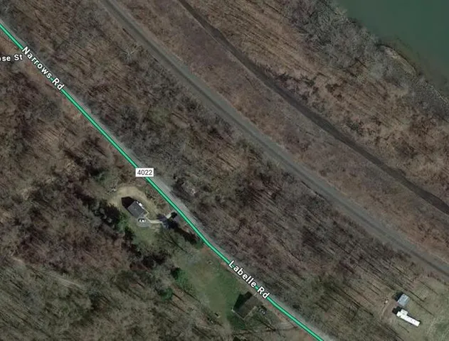 a view of a yard with wooden fence