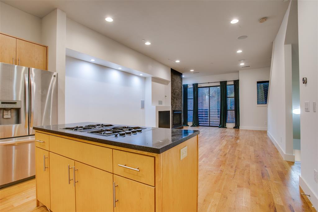 4618 Cedar Springs Road, Unit D Dallas, TX 75219 - Photo 17 of 29 a kitchen with stainless steel appliances granite countertop a refrigerator and a stove top oven