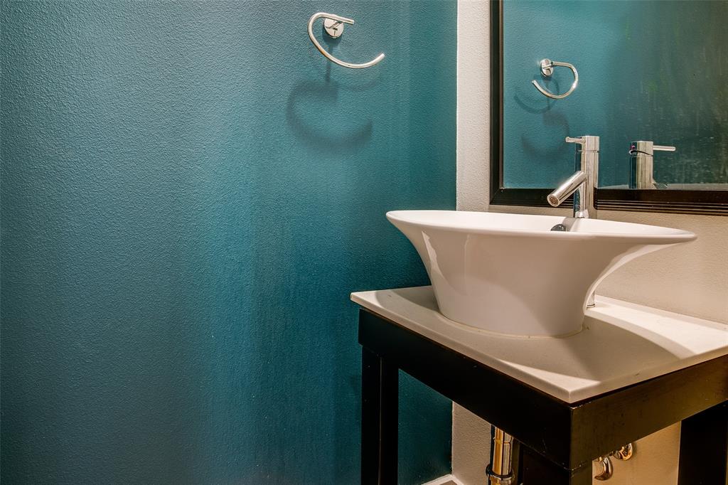 4618 Cedar Springs Road, Unit D Dallas, TX 75219 - Photo 18 of 29 a bathroom with a sink and a mirror