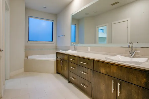a bathroom with a double vanity sink and mirror