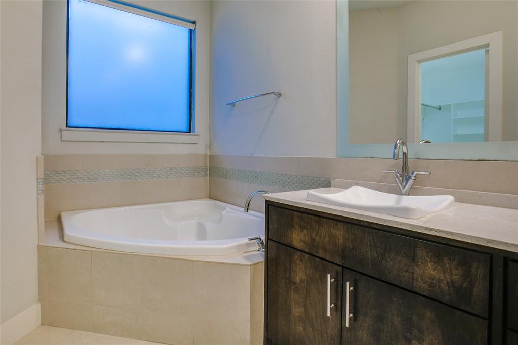 4618 Cedar Springs Road, Unit D Dallas, TX 75219 - Photo 27 of 29 a bathroom with a sink and a bathtub
