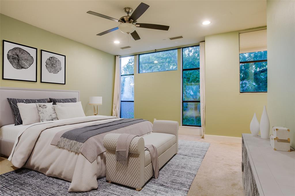 4618 Cedar Springs Road, Unit D Dallas, TX 75219 - Photo 5 of 29 a bedroom with a large bed and a chandelier