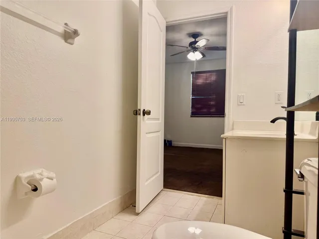 a bathroom with a light fixture and a glass door