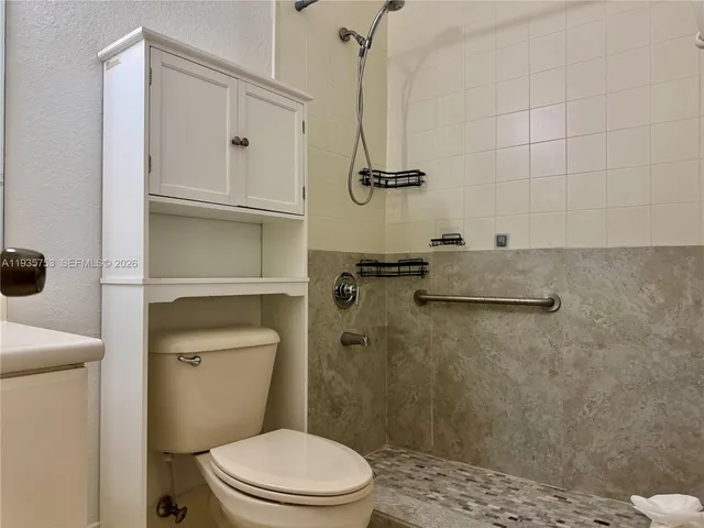 a bathroom with a toilet and a shower