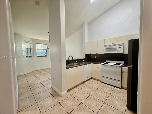 a kitchen with a stove top oven and cabinets