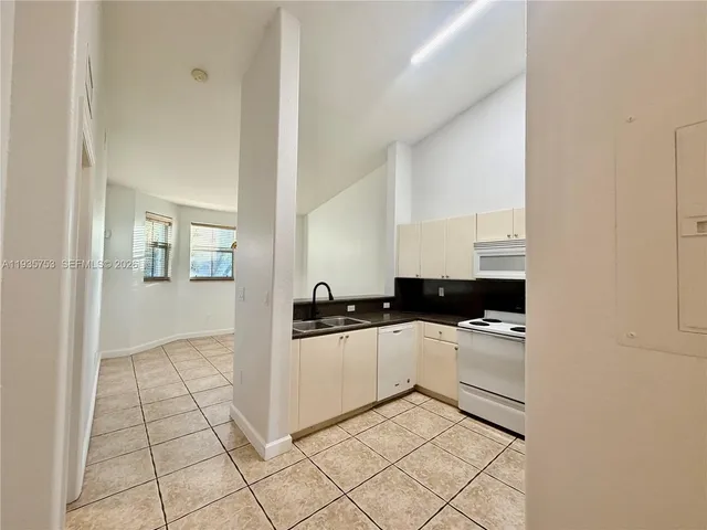 a kitchen with a stove top oven and cabinets