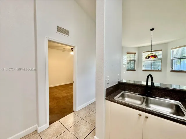 a kitchen with a sink and a refrigerator