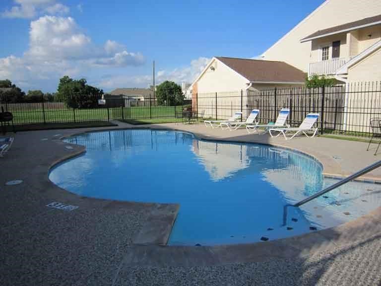 14020 Schroeder Road, Unit 151 Houston, TX 77070 - Photo 24 of 26 a view of a swimming pool with a lounge chairs