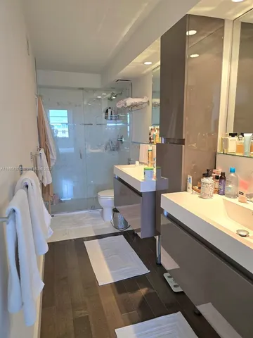a bathroom with a sink a toilet and a mirror