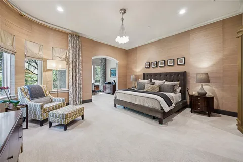 a bedroom with bed and a large window