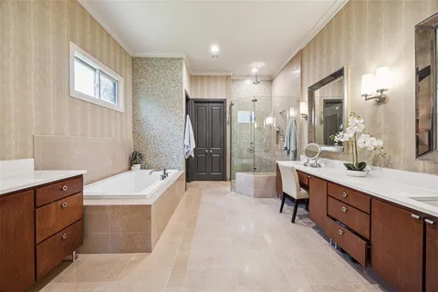 a bathroom with a double vanity sink a toilet a mirror and shower