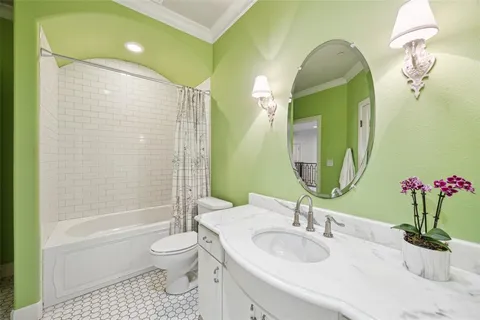 a bathroom with a granite countertop sink a toilet and shower