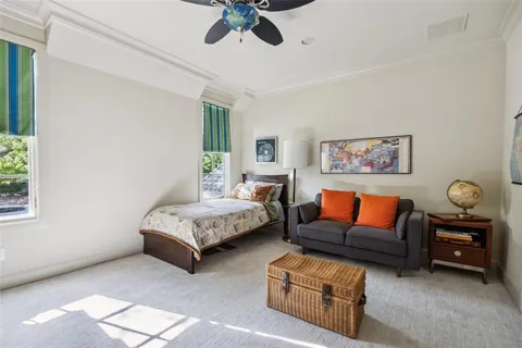 a living room with furniture ceiling fan and a window