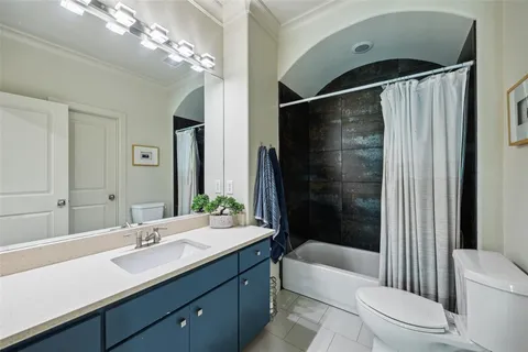 a bathroom with a double vanity sink toilet and shower