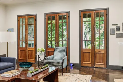 a living room with furniture and floor to ceiling windows