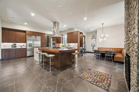 a kitchen with a table chairs and a view of living room