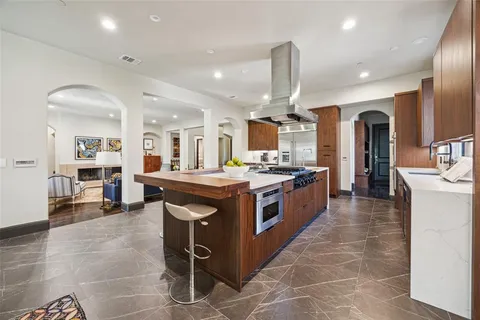 a large kitchen with stainless steel appliances kitchen island granite countertop a large counter top and stove