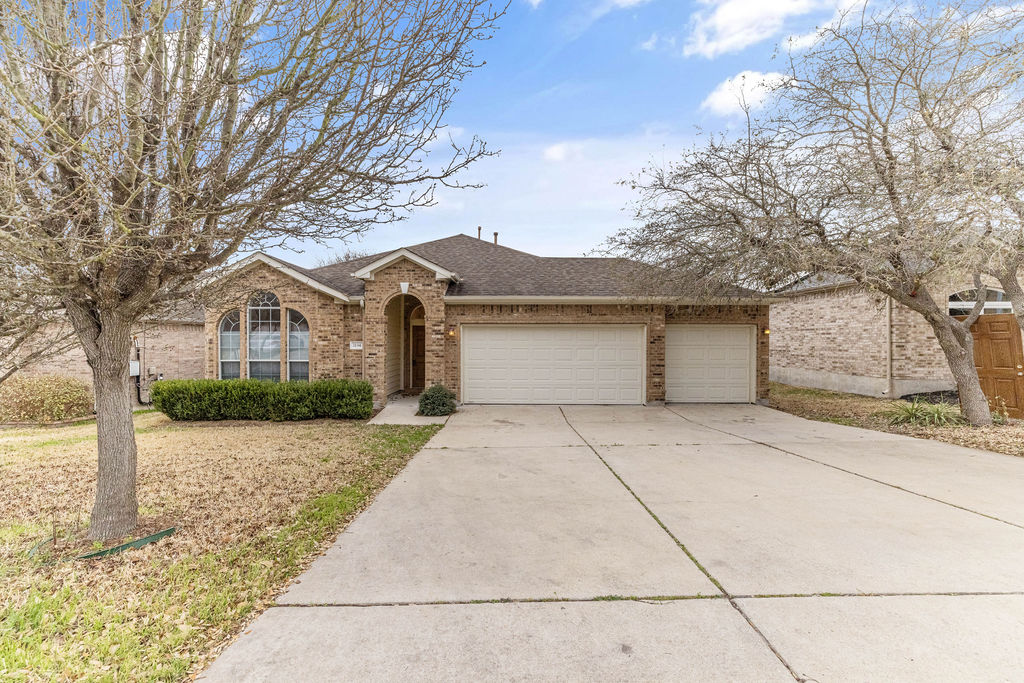 2134 Paradise Ridge Drive Round Rock, TX 78665 - Photo 1 of 28 a front view of a house with a yard and garage