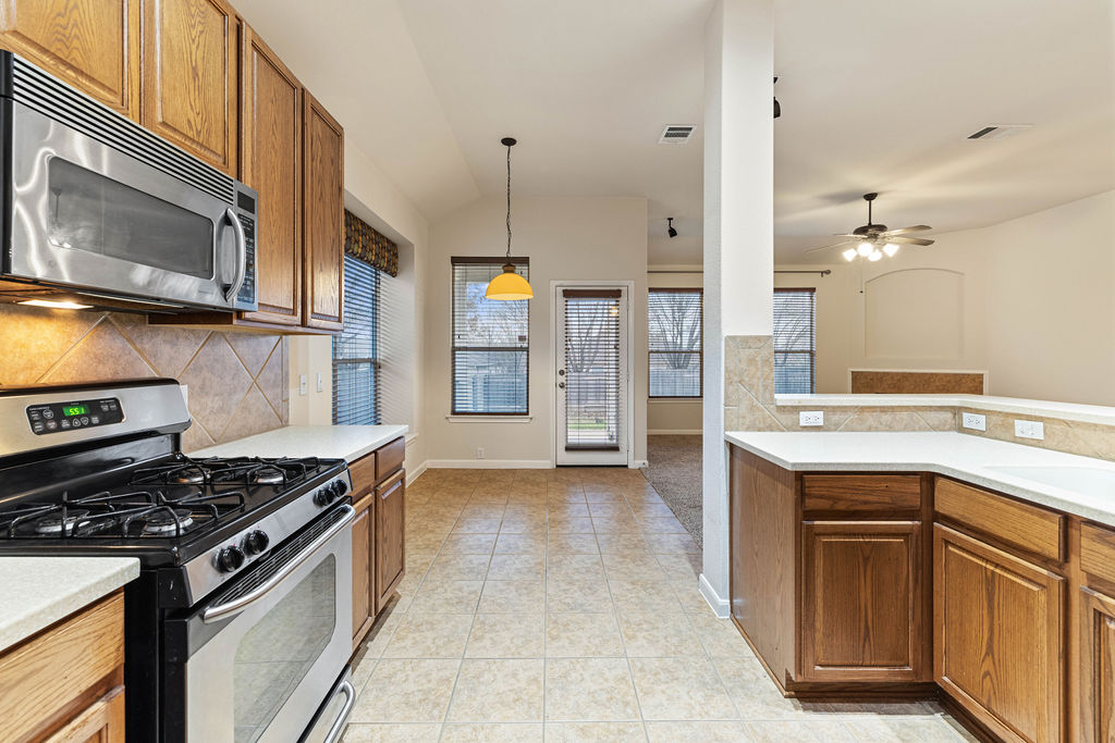 2134 Paradise Ridge Drive Round Rock, TX 78665 - Photo 8 of 28 a kitchen with a stove and a sink
