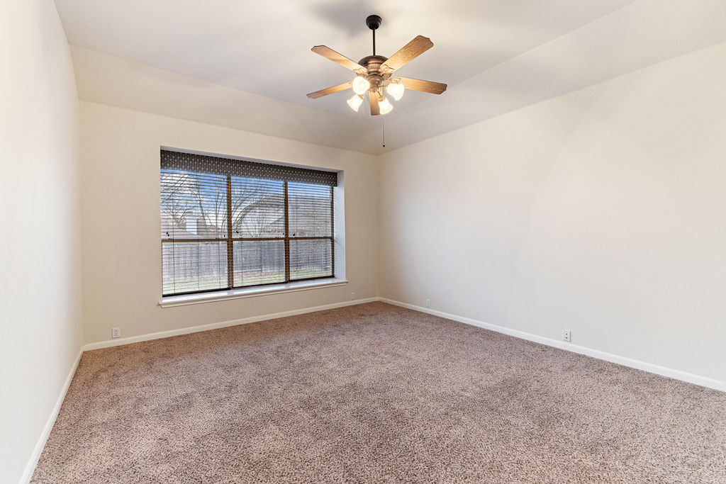 2134 Paradise Ridge Drive Round Rock, TX 78665 - Photo 14 of 28 an empty room with chandelier fan and windows