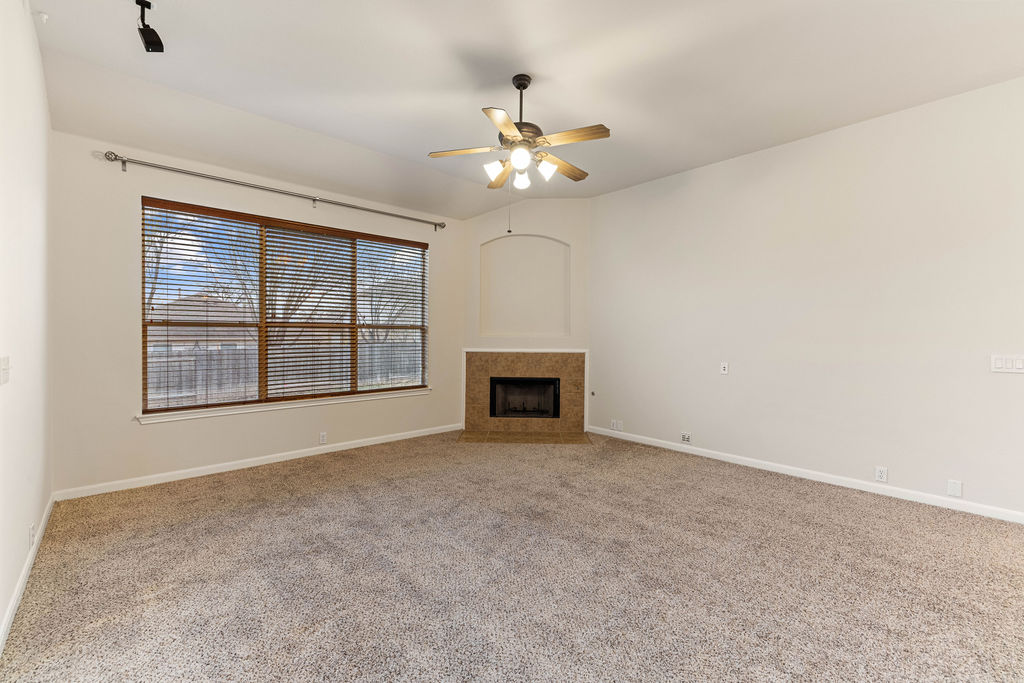 2134 Paradise Ridge Drive Round Rock, TX 78665 - Photo 5 of 28 an empty room with chandelier fan and windows