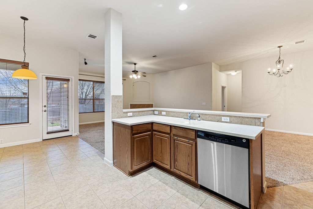 2134 Paradise Ridge Drive Round Rock, TX 78665 - Photo 28 of 28 a large kitchen with a sink and dishwasher a stove top oven with a dishwasher
