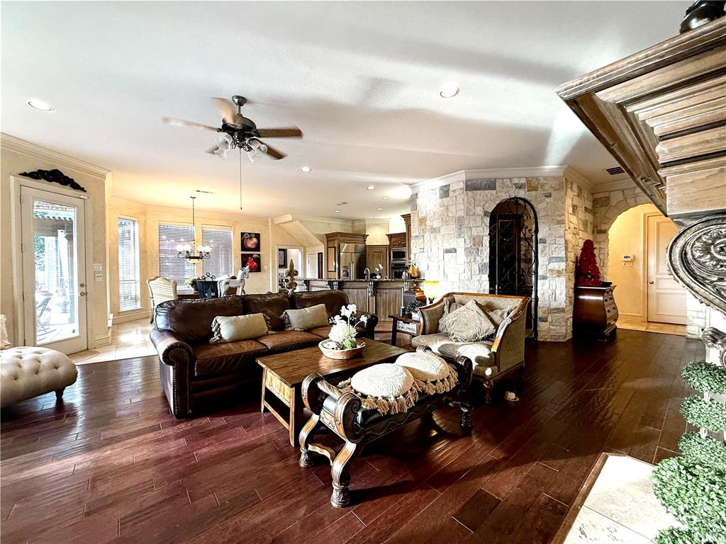 1919 Kings Pass Heath, TX 75032 - Photo 14 of 38 Living area featuring hardwood floors, a ceiling fan, and stone accents
