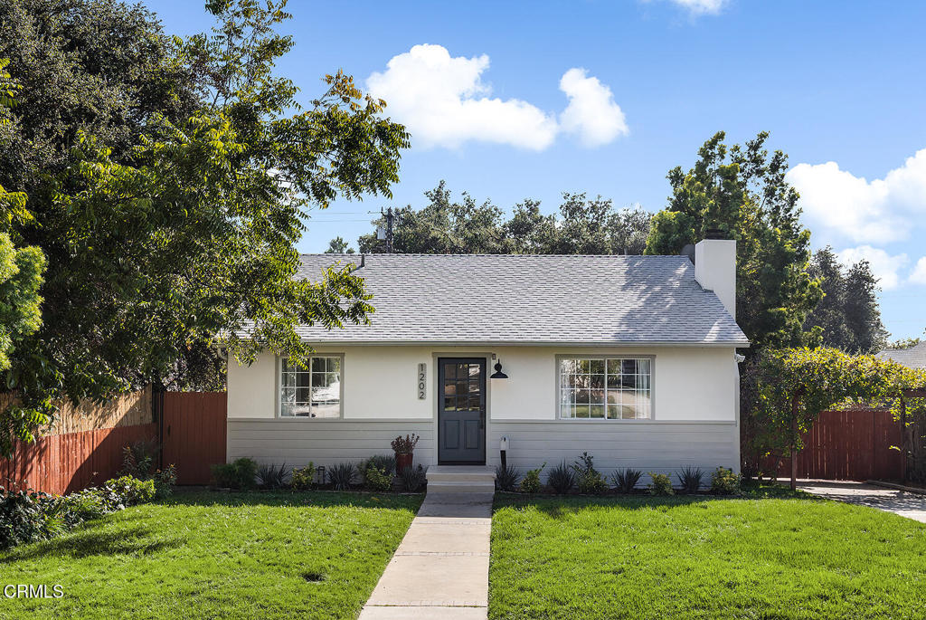 1202 East Lexington Street Pasadena, CA 91104 - Photo 2 of 39 a front view of a house with a garden and trees