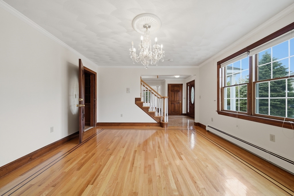 131 Range Heights Road Lynn, MA 01904 - Photo 6 of 36 a view of an empty room with wooden floor and a window