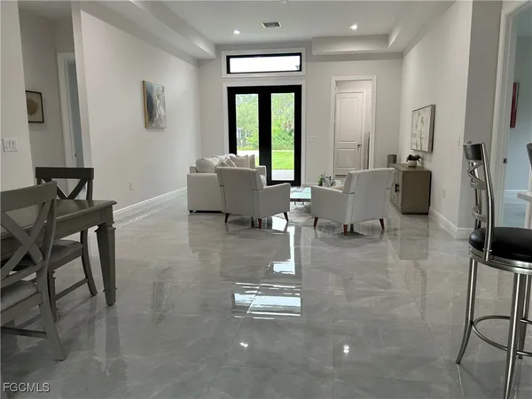 a living room with furniture and a large window