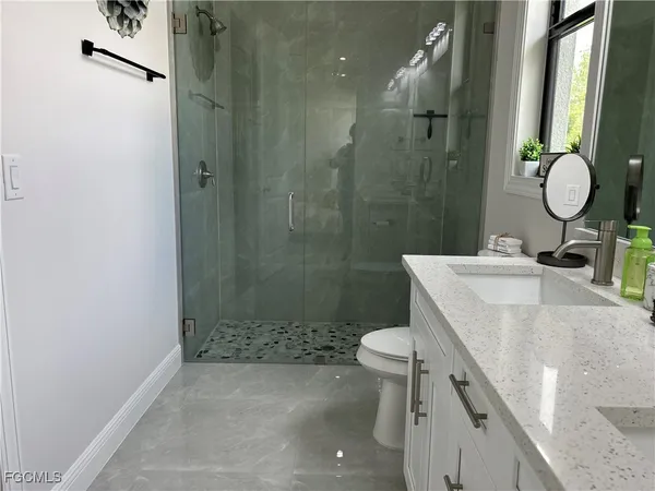 a bathroom with a sink toilet and shower