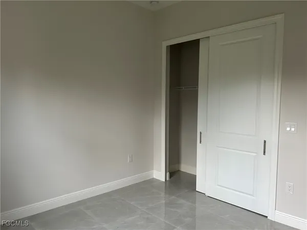 an empty room with closet area