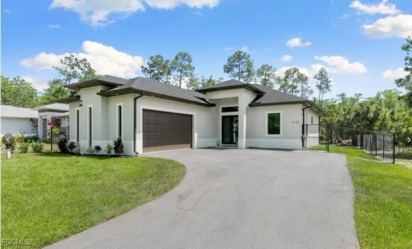 a view of a house with yard and a garden