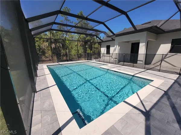 a view of a backyard with table and chairs under an umbrella