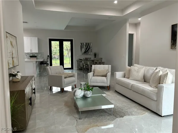 a living room with furniture a fireplace and a window