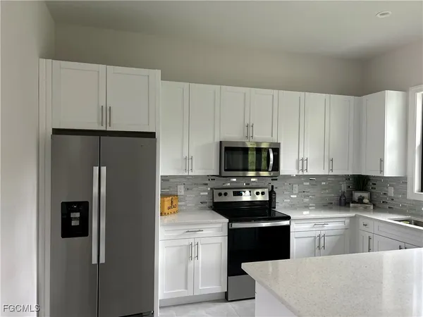 a kitchen with a refrigerator stove and microwave