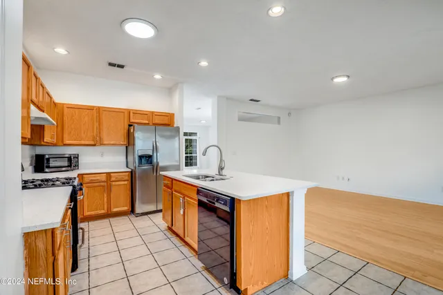 a kitchen with stainless steel appliances granite countertop a sink and cabinets