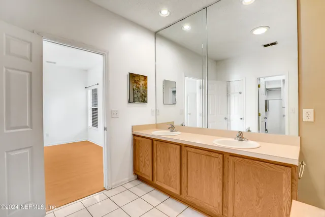 a bathroom with a sink a mirror and a shower