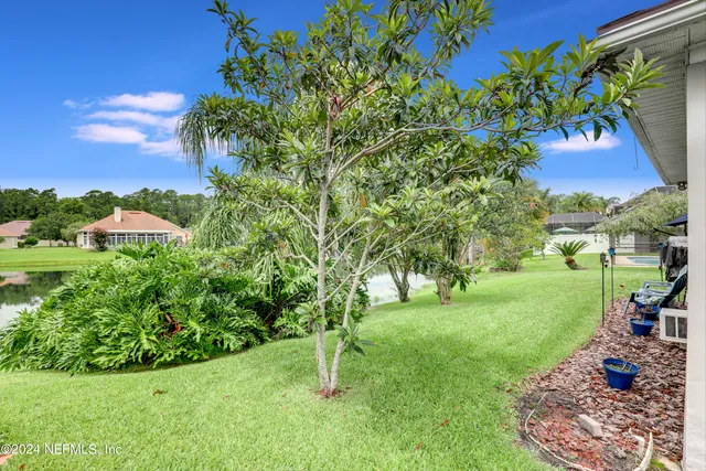 a view of a street with a house in the background